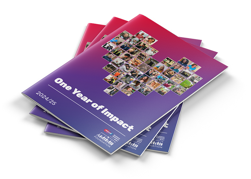A stack of printed copies of the One Year of Impact Report 2024-2025 for the nBS Foundation